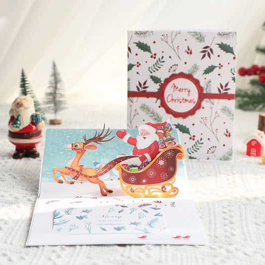 3D pop-up Christmas card featuring Santa Claus and reindeer sleigh