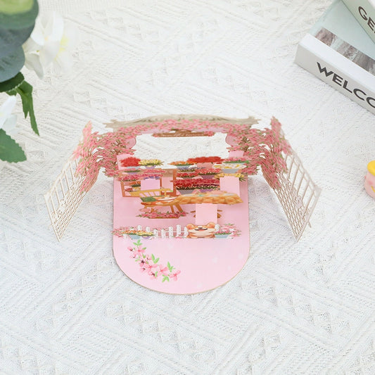 Top view of the garden pop-up card showing the layout of the tea table, potted plants, and paper engineering structure