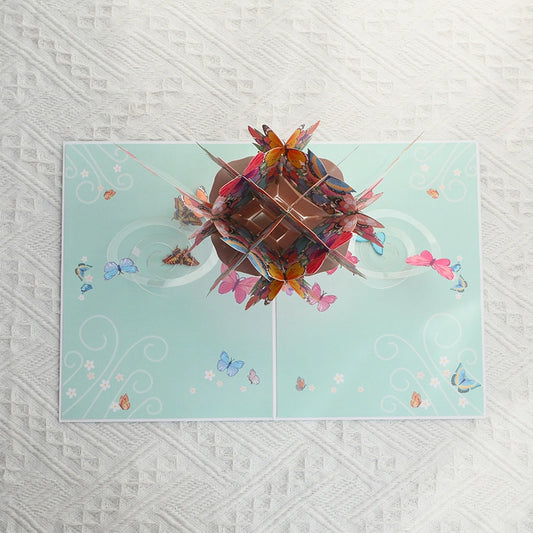 Light blue card cover featuring a printed illustration of a butterfly bouquet with a pink ribbon.