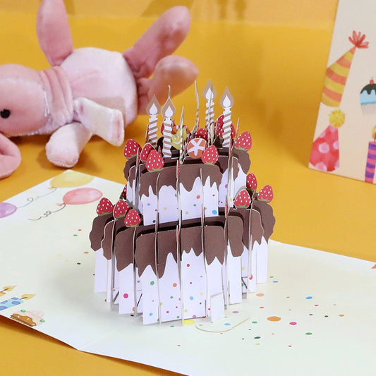 Close-up side view of the 3D paper cake card highlighting the chocolate frosting details and strawberry decorations.