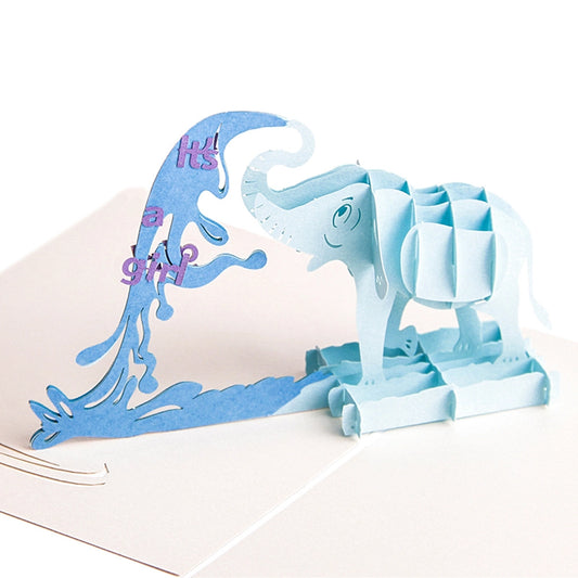 Front view of adorable blue baby elephant 3D card with purple "It's a girl" text inside the water spray