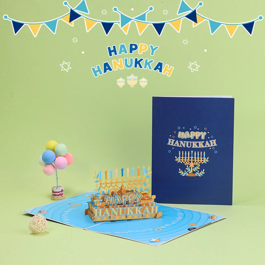 Happy Hanukkah 3D pop-up card open showing golden Menorah with blue and orange candles