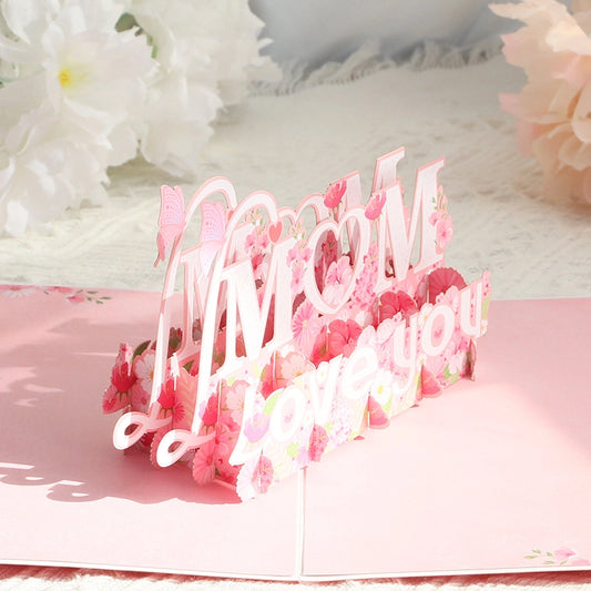 Inside view of flat pop-up card showing red paper engineering mechanism and floral corners