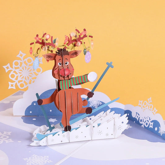 Open 3D pop-up Christmas card featuring a cute reindeer skiing on snow with colorful lights on antlers.