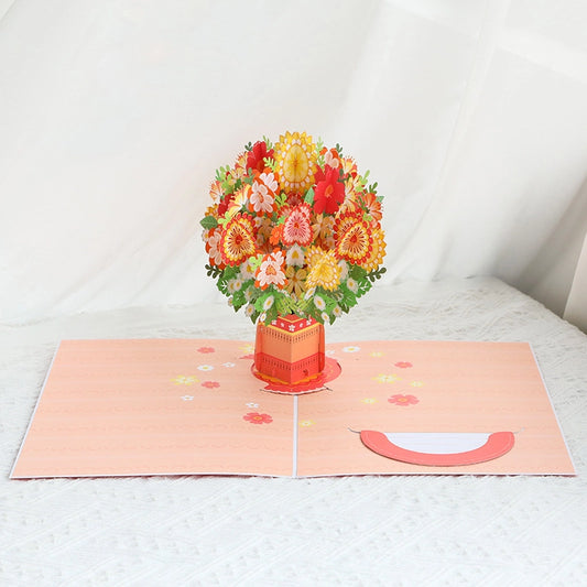 Warm Bouquet 3D Pop-Up Card open showing orange and red flowers in a vase on a peach background