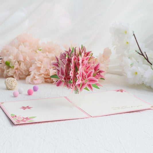 Side view of pink lily flower pop-up card highlighting detailed paper petals and green leaves