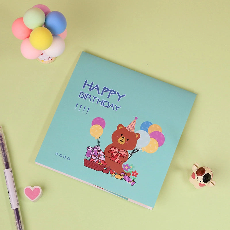Cute bear birthday pop-up card with colorful balloons and birthday gift illustration