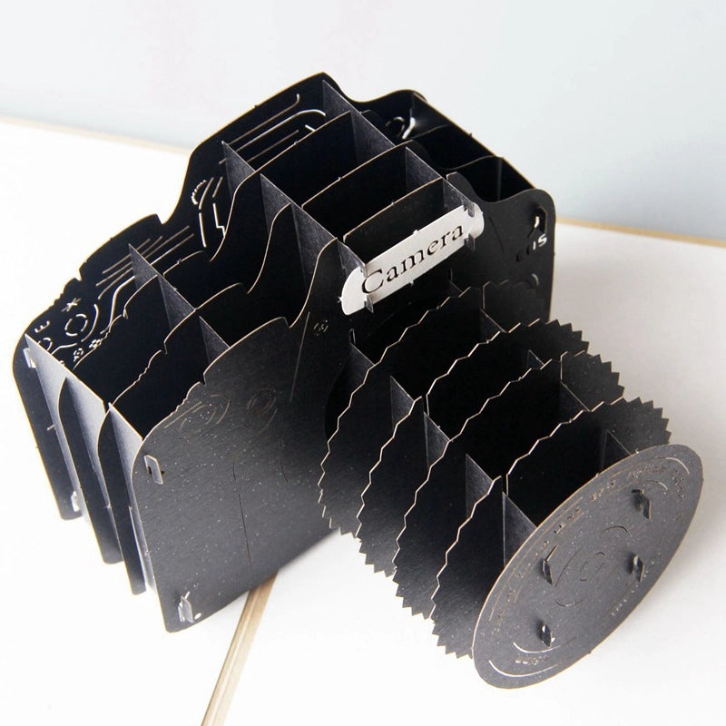 Close-up of detailed layered black camera inside a 3D pop-up card