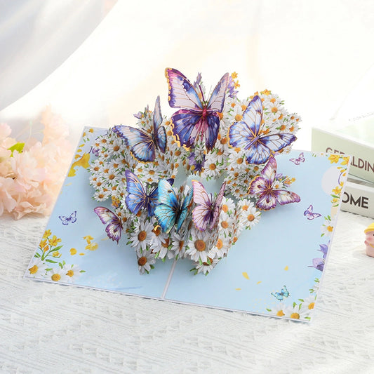 Lifestyle shot of the floral butterfly greeting card standing open on a white table
