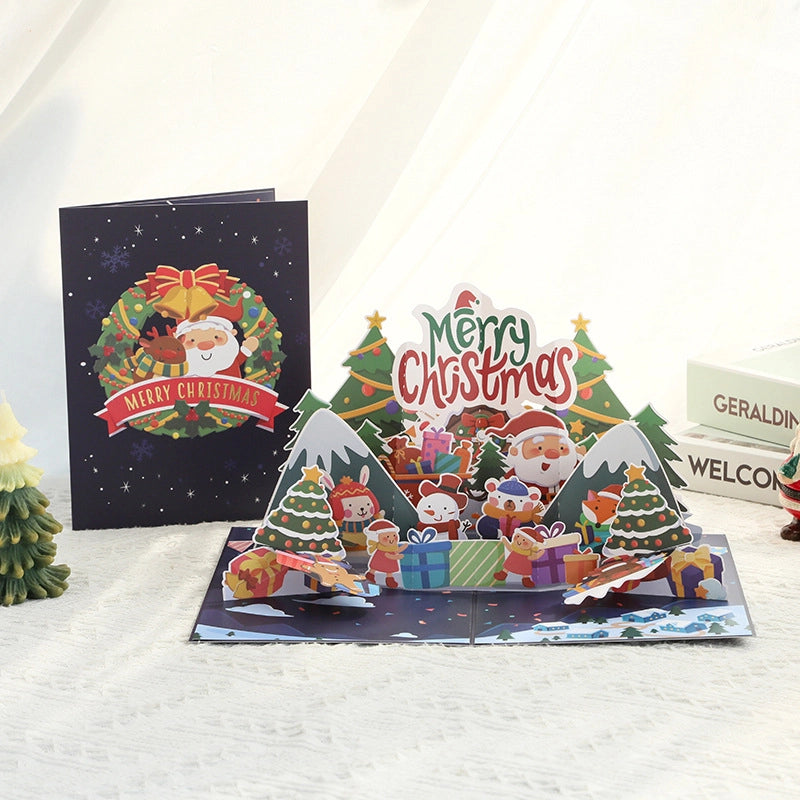 3D pop-up Christmas card featuring Santa Claus, Christmas trees, gifts and Merry Christmas design