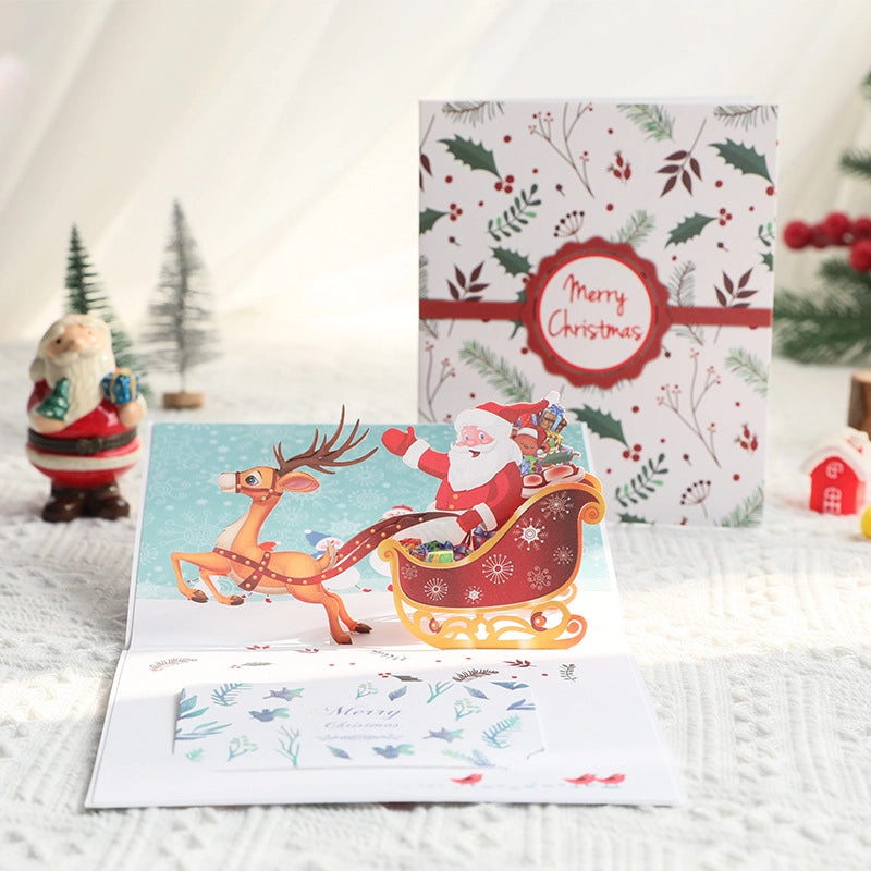 3D pop-up Christmas card featuring Santa Claus and reindeer sleigh