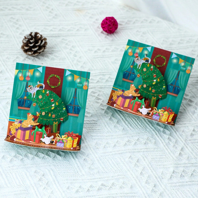 Open Christmas pop-up card featuring cats and decorated Christmas tree