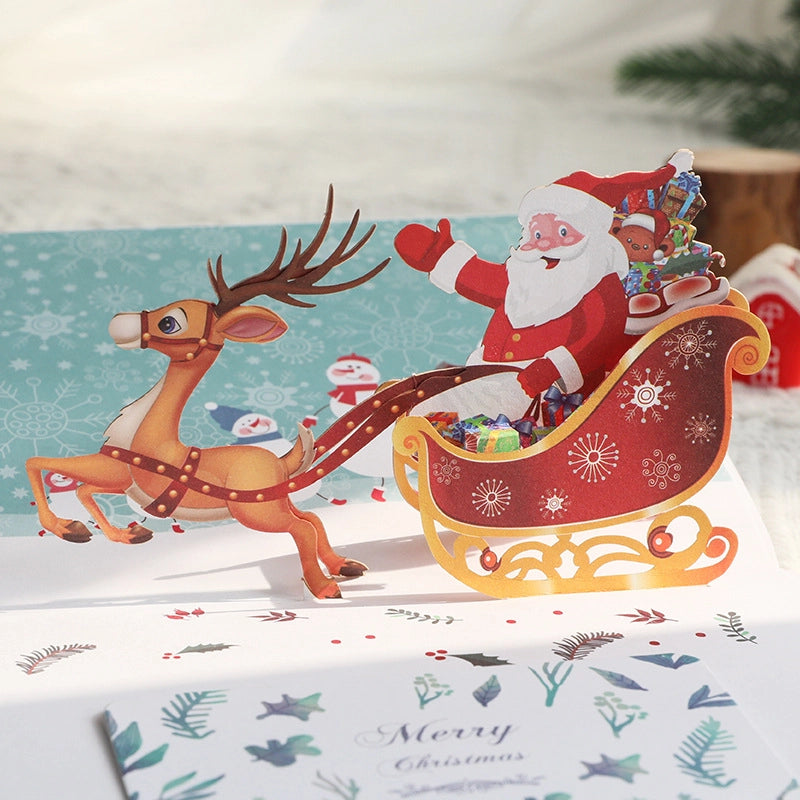 Close-up of Santa Claus and reindeer sleigh on 3D Christmas pop-up card