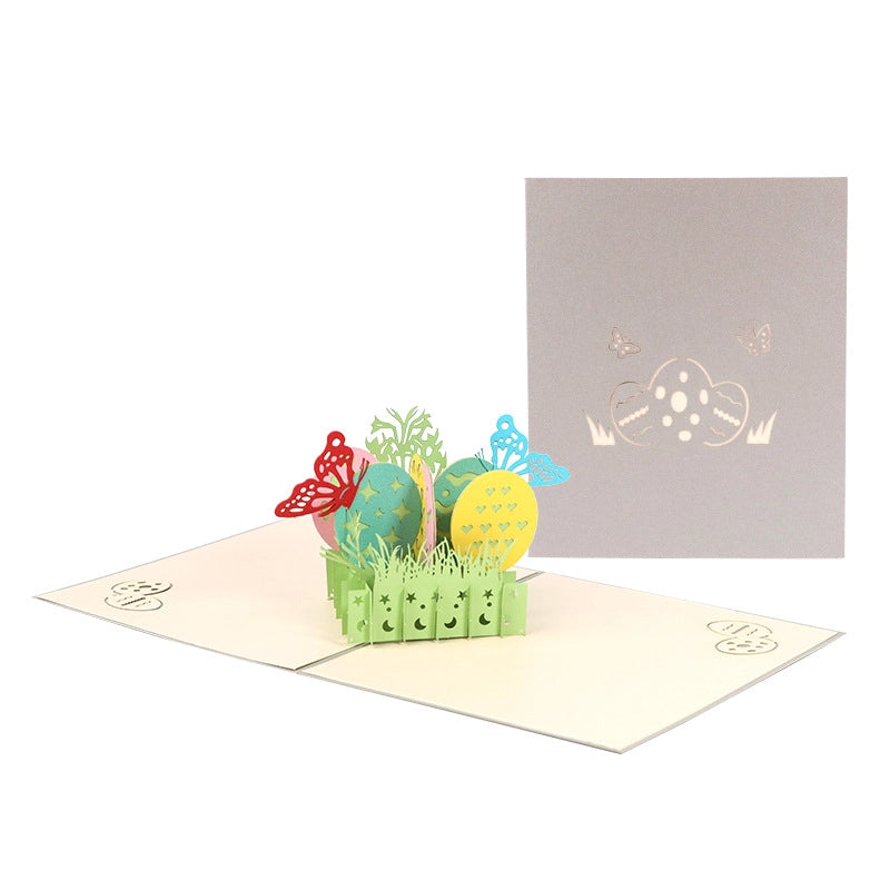 Full view of the open Easter pop-up card next to its closed cover on a white background, displaying the complete 3D garden scene.
