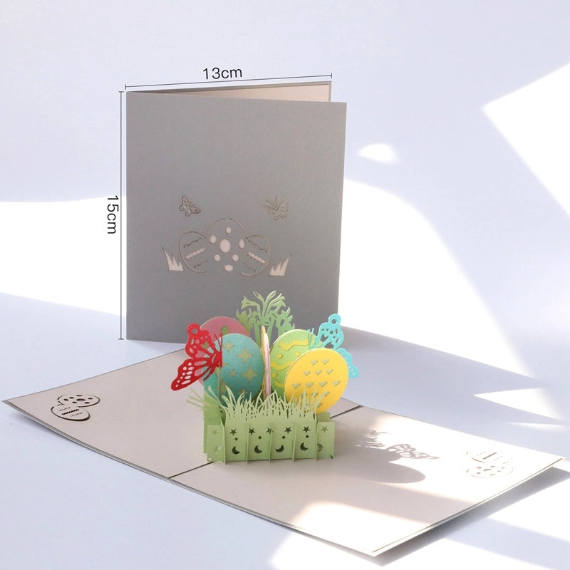 Dimensions of the Easter egg pop-up card showing 15cm height and 13cm width, with the 3D egg and butterfly structure fully extended.