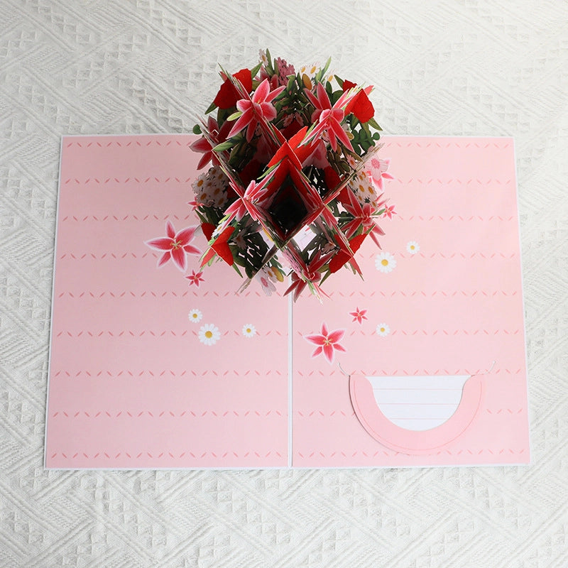 Top-down view showing the intricate layering of the 3D flower bouquet and the pink patterned interior of the card