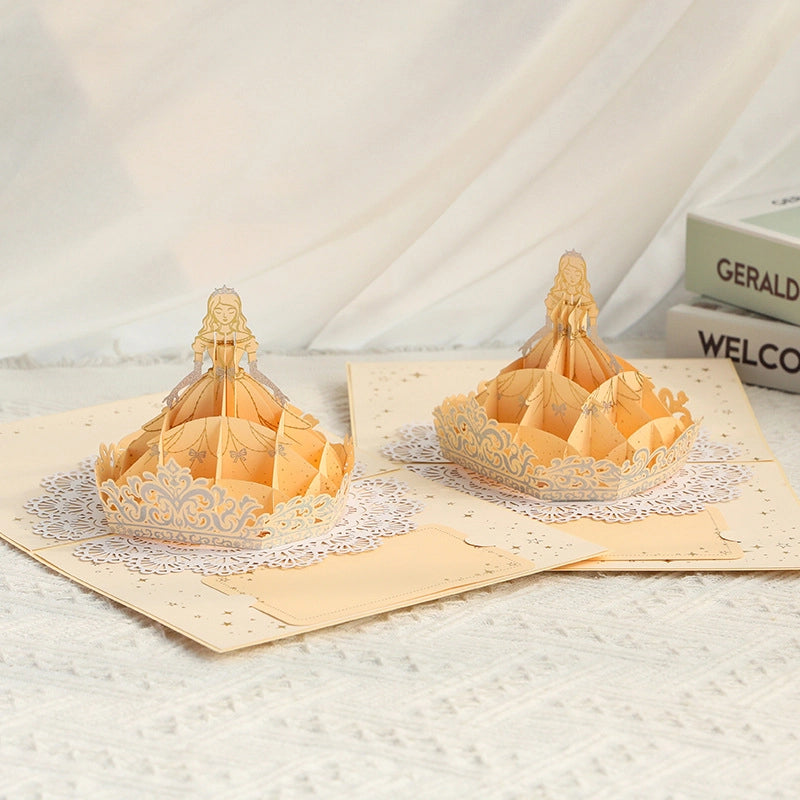 Detailed 3D pop-up princess card featuring a golden dress, crown and lace-inspired decorative design