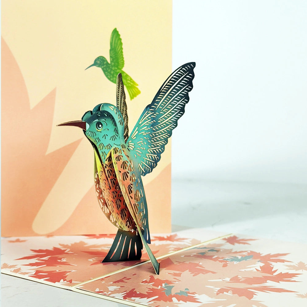 Colorful 3D pop-up hummingbird card standing upright when opened