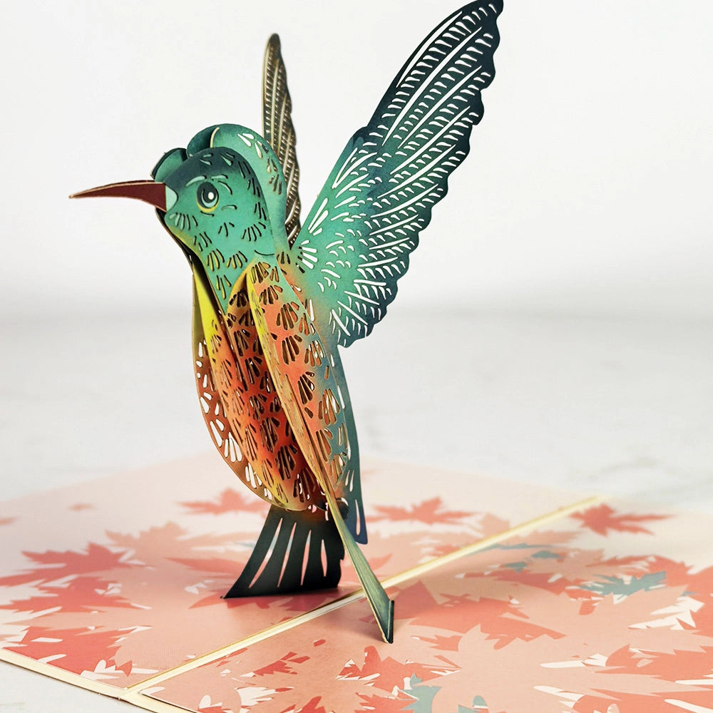 Detailed 3D hummingbird pop-up greeting card showing layered wings and feathers