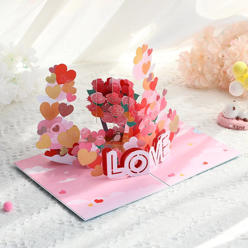 Side angle view of romantic 3D greeting card showing depth of paper rose bouquet and heart layers