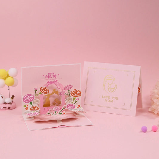 Comparison view of the closed "I Love You Mom" card cover next to the fully opened 3D floral pop-up greeting card.