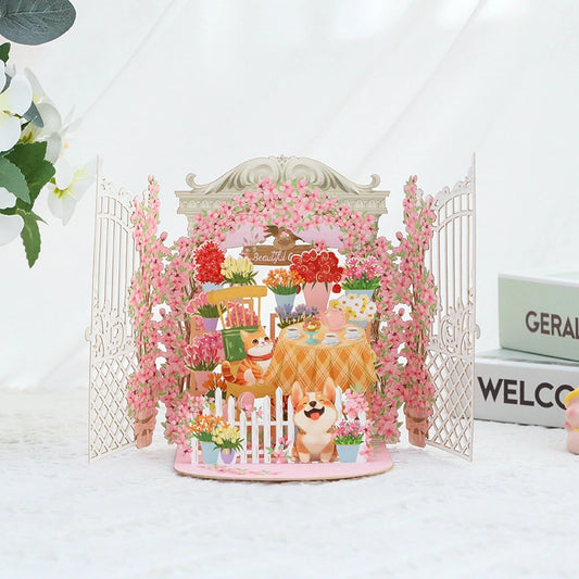 3D pop-up card opening to reveal a secret garden scene with a cat reading and a corgi dog among pink flowers