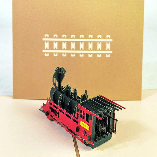 3D steam train pop-up card with red locomotive emerging from the card