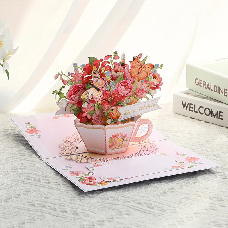 Detailed view of paper art teacup filled with colorful flowers and Best Wishes banner