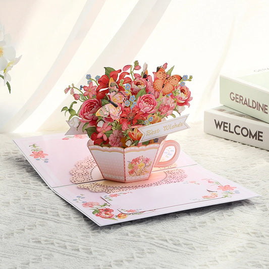 Detailed view of paper art teacup filled with colorful flowers and Best Wishes banner