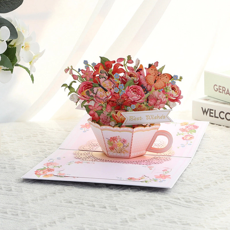 Side view of 3D pop-up teacup card with red roses and orange butterflies