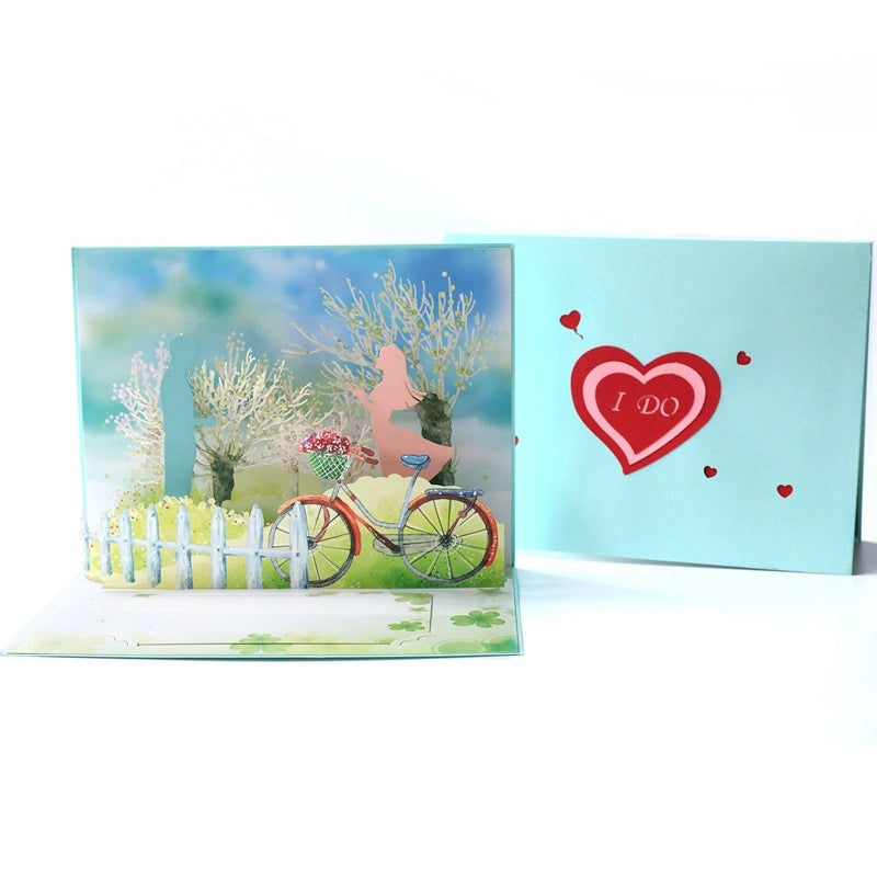 Light blue greeting card cover with a red heart cutout saying "I DO" surrounded by small hearts.