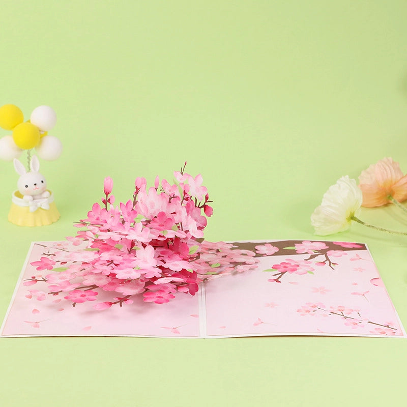 Open 3D cherry blossom greeting card with blooming pink flowers