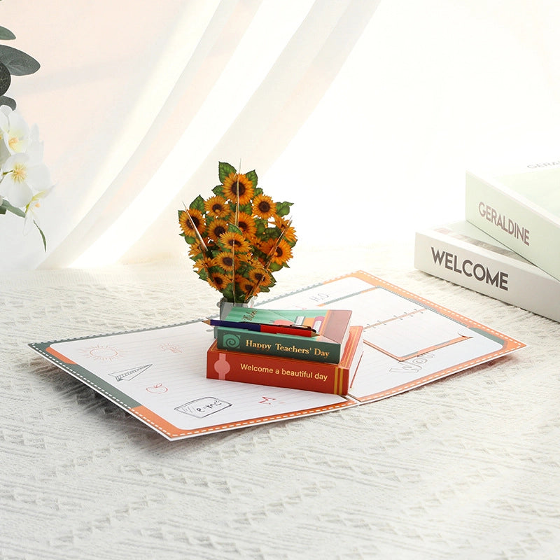 Open 3D Pop-Up Teacher's Day Card featuring a sunflower bouquet and books