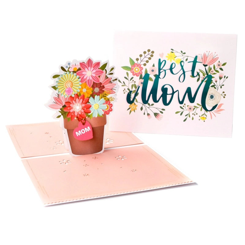 Best Mom 3D pop-up card open showing colorful paper flower pot bouquet and pink cover with floral wreath design
