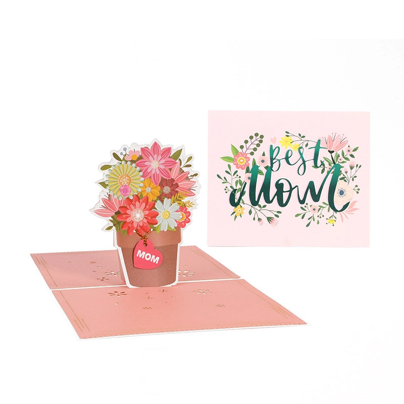 Best Mom 3D pop-up card open showing colorful paper flower pot bouquet and pink cover with floral wreath design
