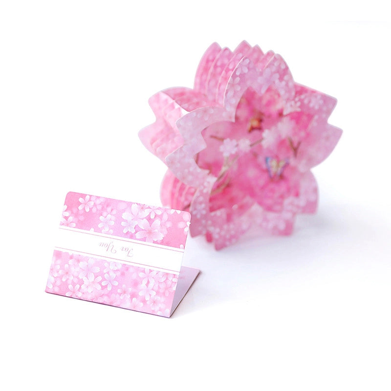 Pink Sakura 3D greeting card opened next to a matching floral envelope labeled "For You", white background
