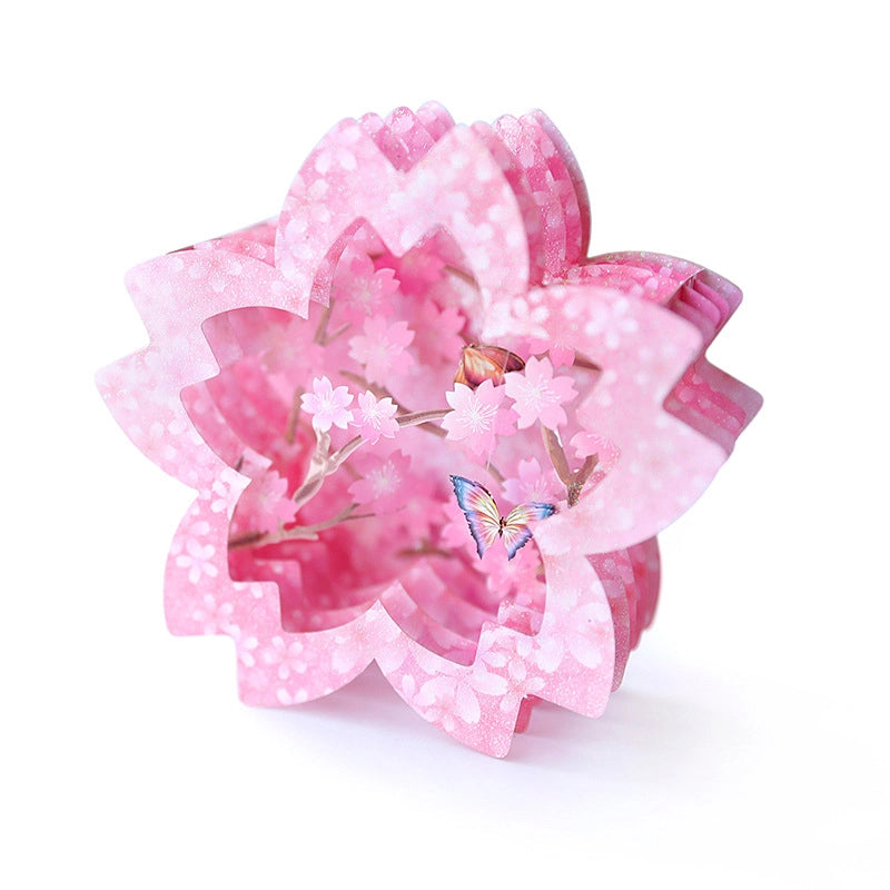 Side angle view of a single pink 3D paper flower pop-up card showing depth and layering of the petals
