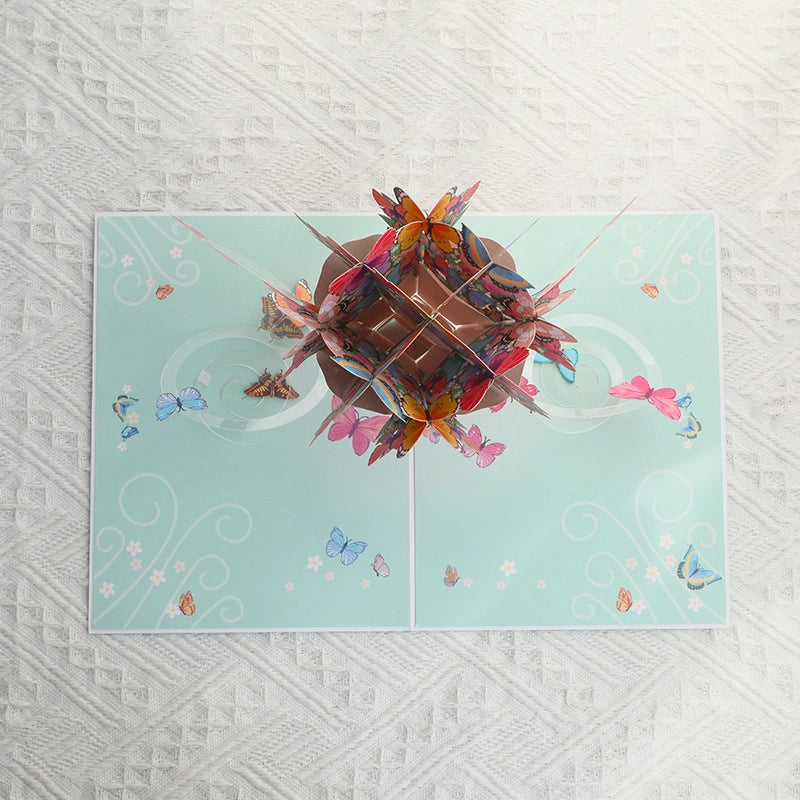 Light blue card cover featuring a printed illustration of a butterfly bouquet with a pink ribbon.