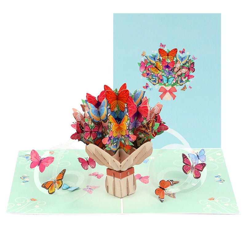 Close up of intricate butterfly paper cutouts rising from the center of the greeting card.