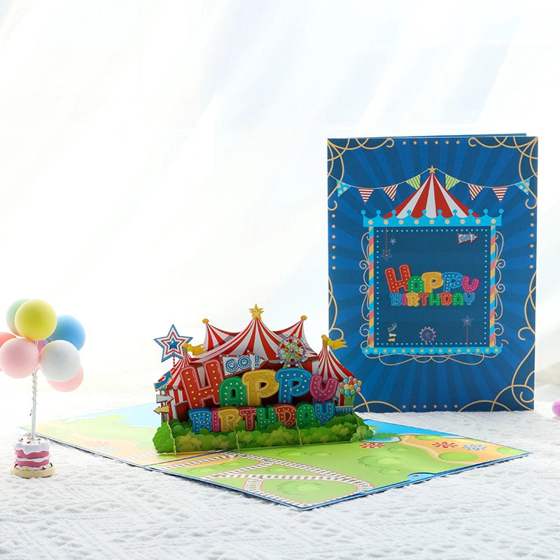 Open Happy Birthday pop-up card with circus tent and balloons on white background, festive greeting card for kids
