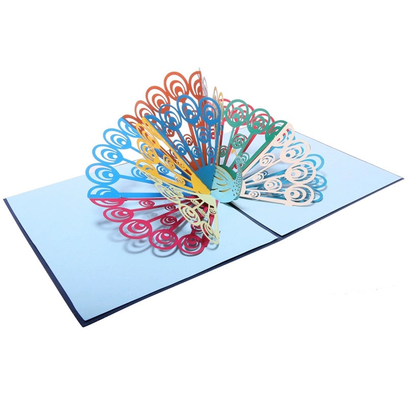 Detailed shot of the intricate laser-cut swirl patterns on the peacock's colorful tail feathers