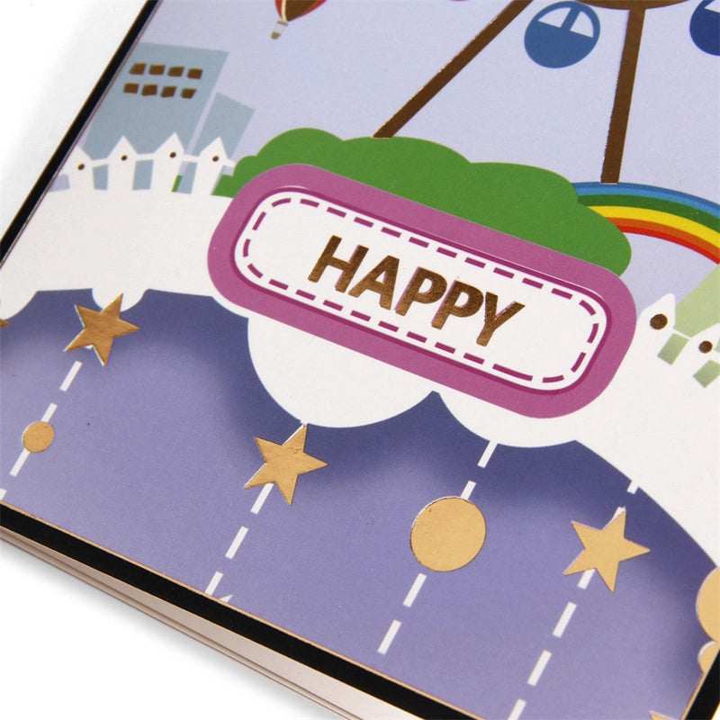Card cover detail showing "HAPPY" text label, gold stars, and colorful hot air balloons.
