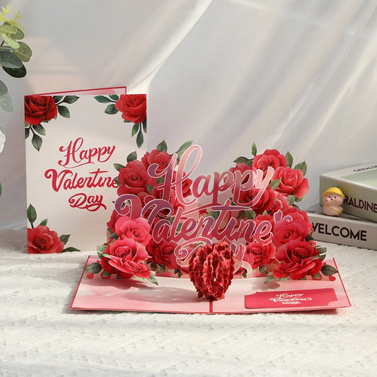 3D pop-up Valentine's Day card with red roses and heart design next to floral envelope

