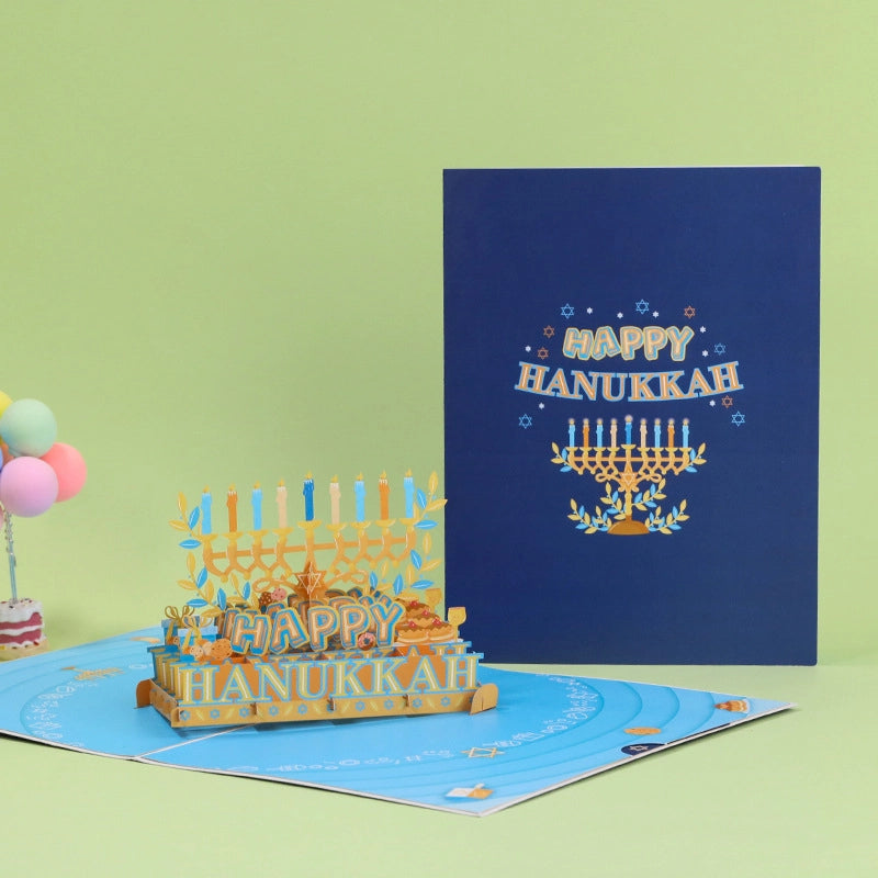 Festive Hanukkah card display with balloons and party decorations