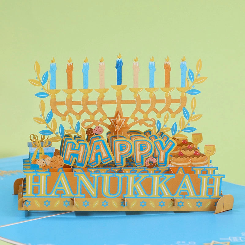 Close up of 3D paper Menorah and Sufganiyot donuts inside Hanukkah greeting card