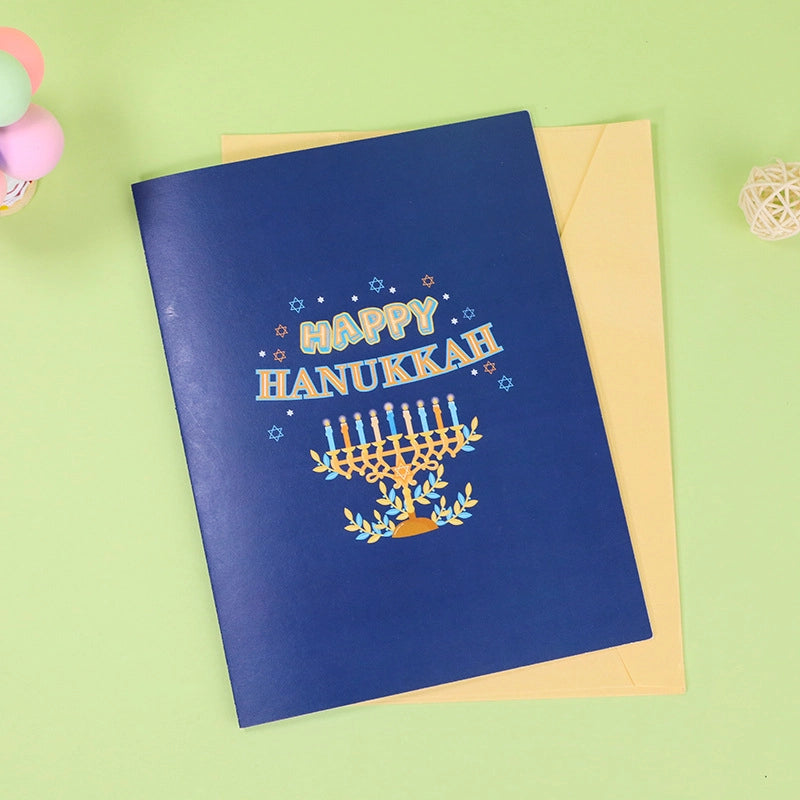 Dark blue envelope and card cover with Happy Hanukkah text and Menorah illustration