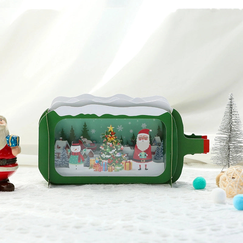 Isolated front view of the green retro TV Christmas card with a festive scene of Santa and gifts behind a transparent window.