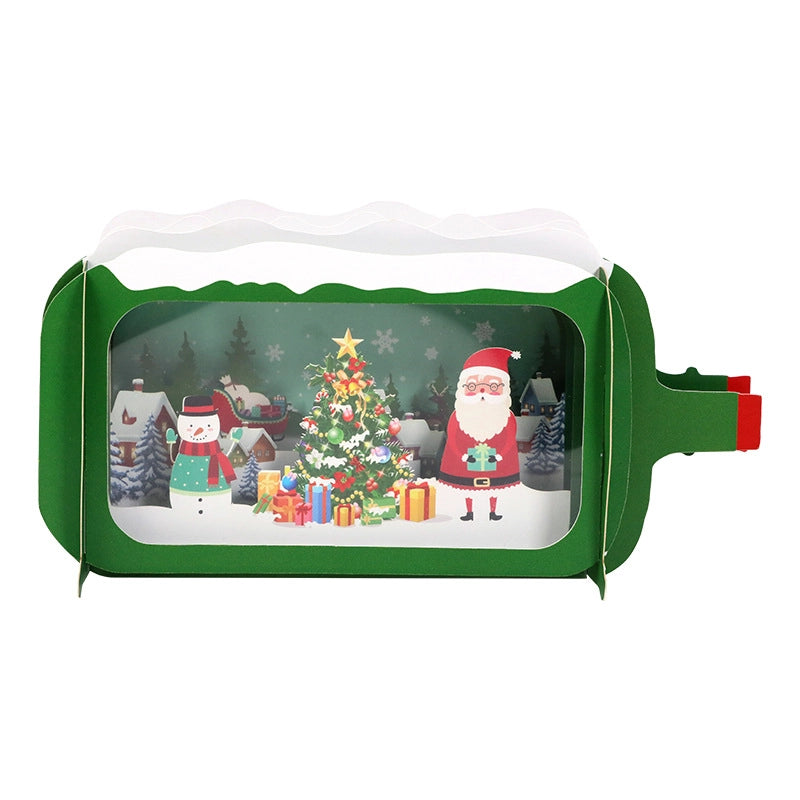 3D perspective of the holiday greeting card shaped like a vintage television, displaying layered paper art and festive winter scenery.