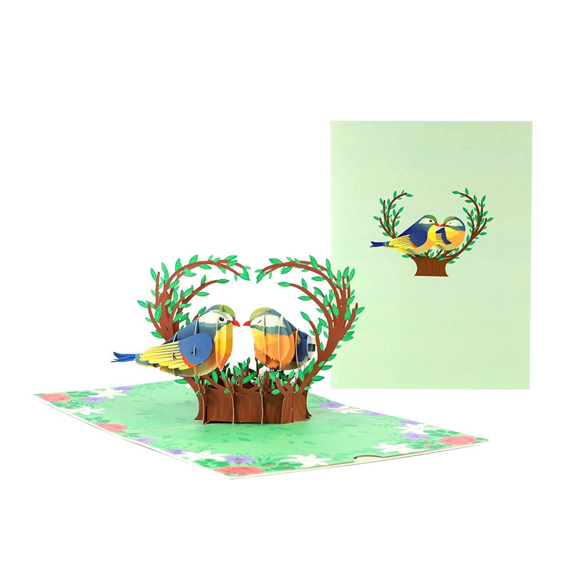 3D pop-up card featuring two love birds on a heart-shaped tree branch with floral border