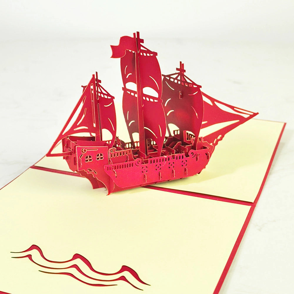 Open sailing ship 3D pop-up card showing handcrafted paper ship and ocean wave details.